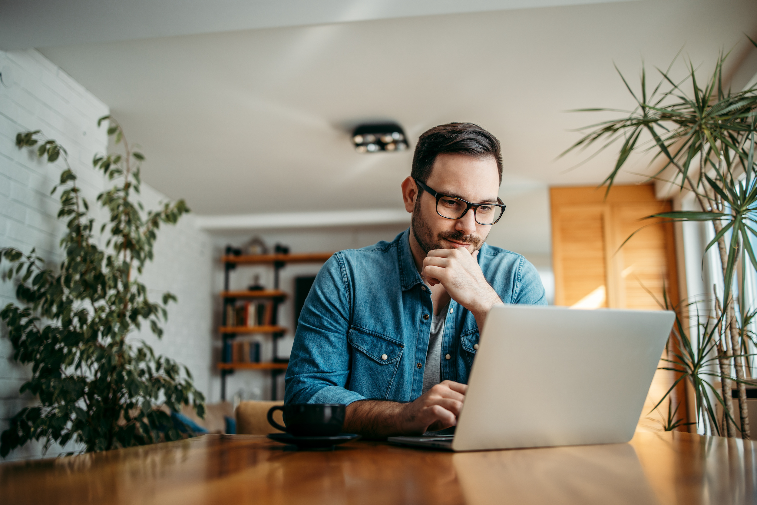 A man sitting at his laptop